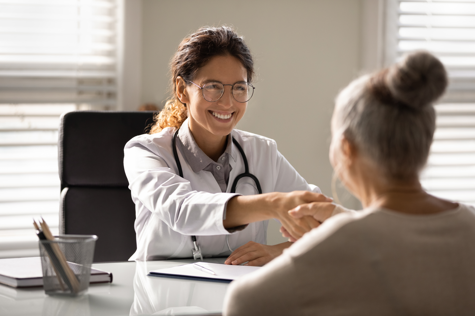 pharmacist shaking hands with patient