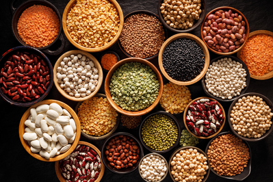 assortment of bowls filled with different types of beans and legumes