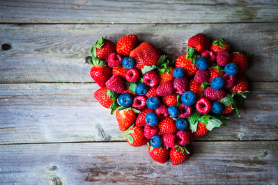 assortment of berries arranged in heart shape