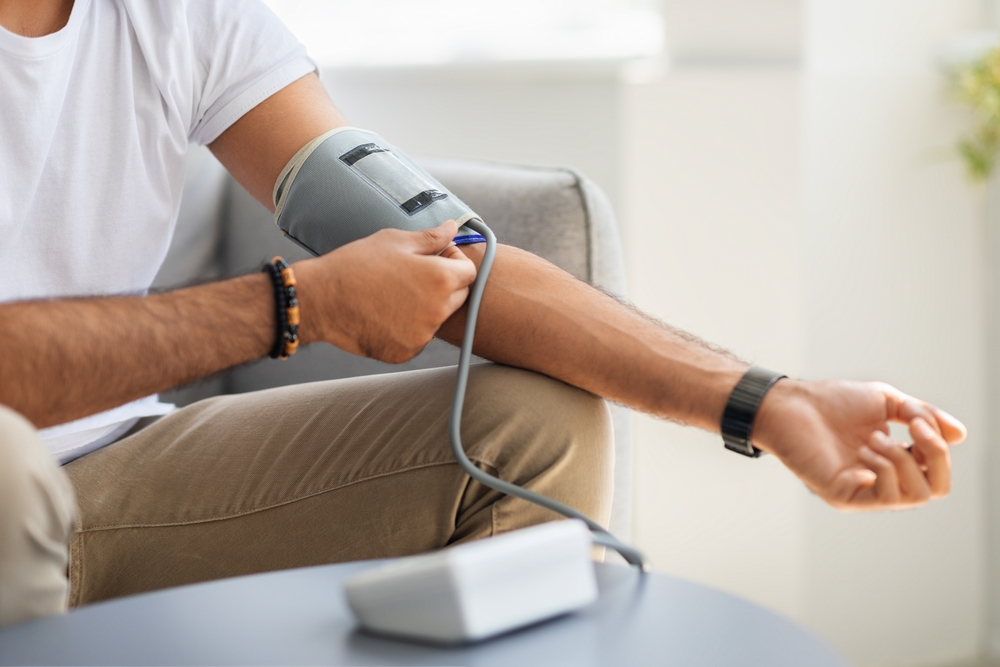 man testing blood pressure at home