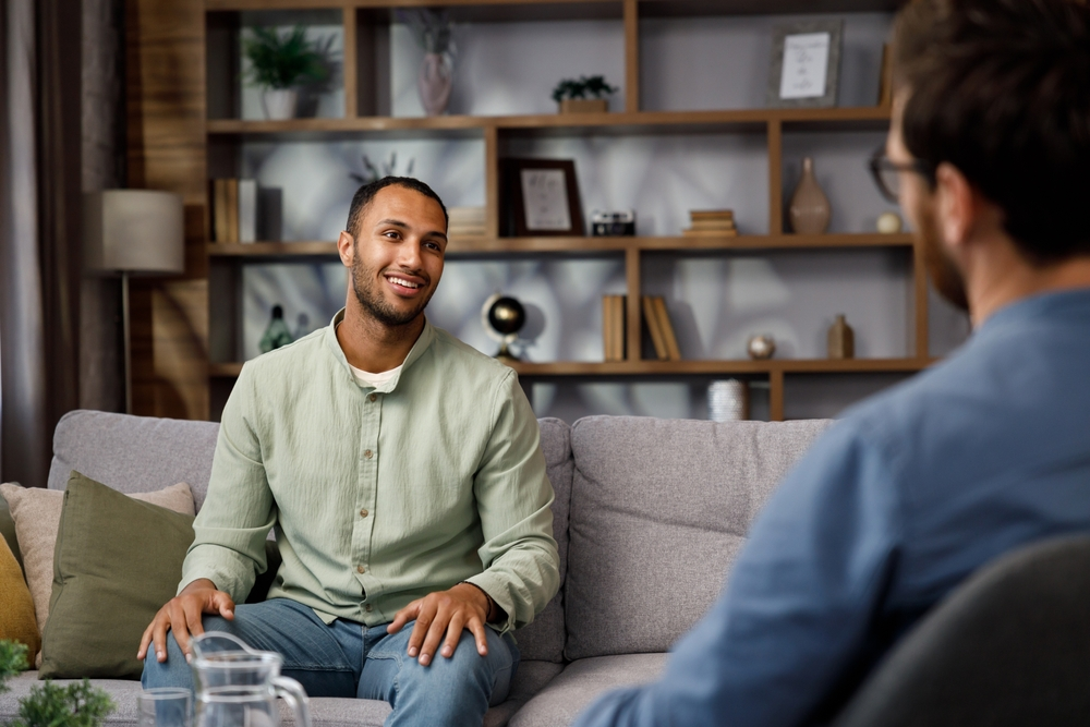 man speaking with psychologist during counseling session