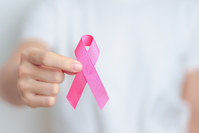 woman holding pink ribbon