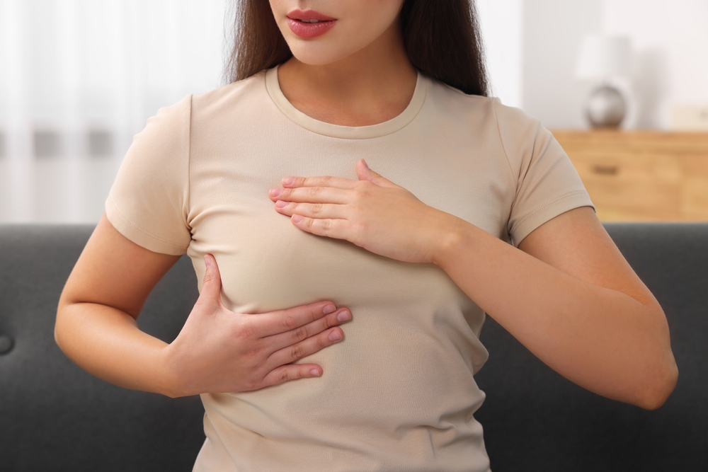 woman checking her own breasts for lumps